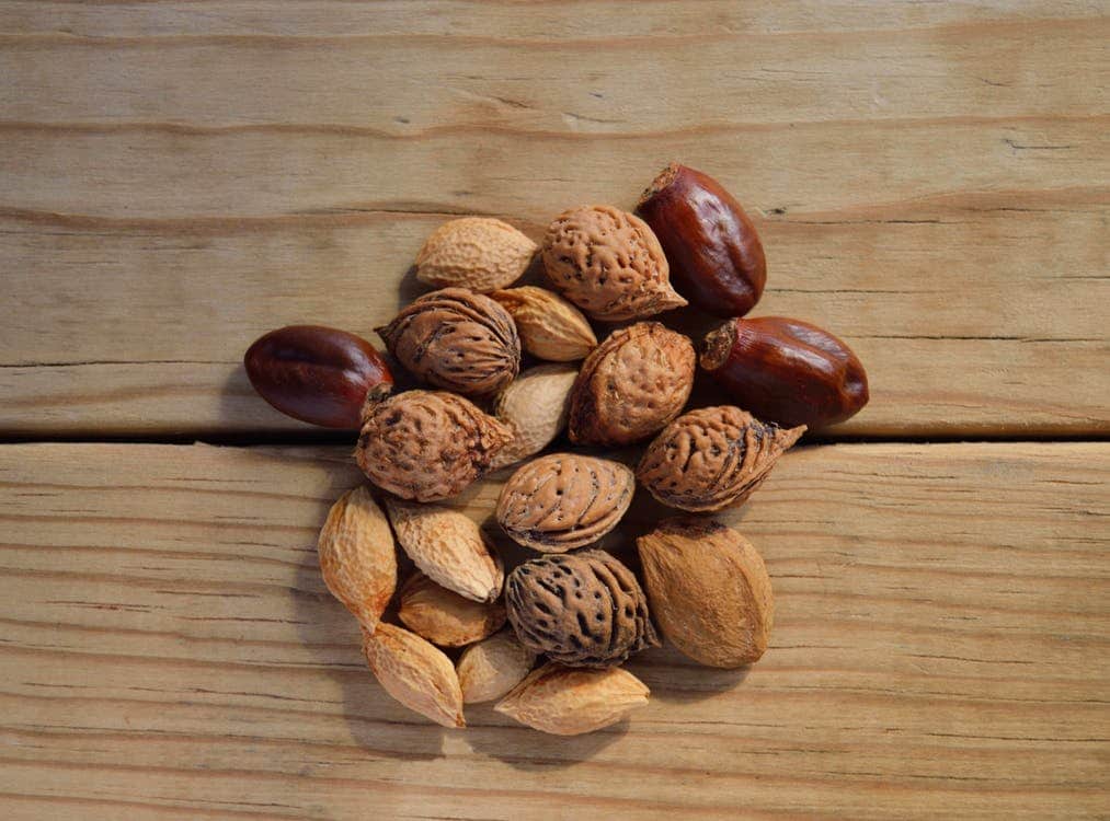 nuts and seed on top of a wooden surface