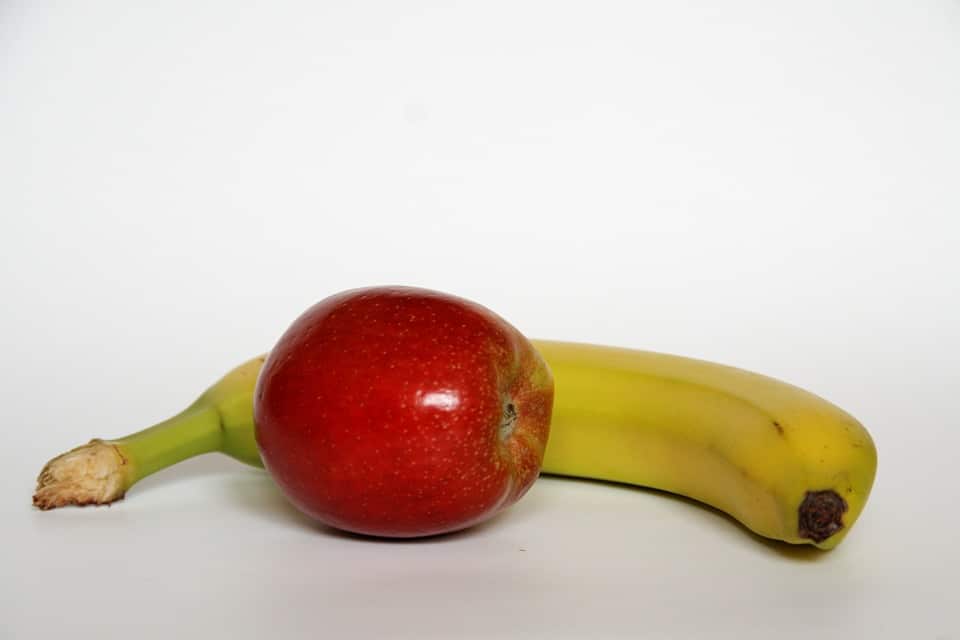 apple and banana on a white surface