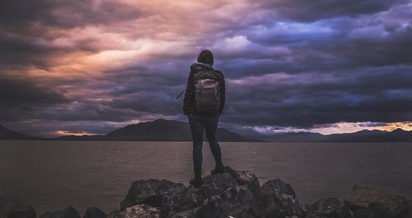 girl standing withhiking backpack